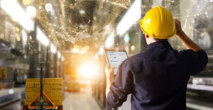 A Factory engineer holding a tablet with Priority Software ERP system Ireland on the screen